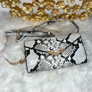 Vegan leather 
Foldover flap with snap closure
Dimensions: 6½" x 1½" x 5"